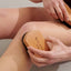 Exfoliating body brushes being used for dry brushing skin on legs