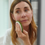 Woman applying BHA exfoliant to her face with a cotton pad, to brighten skin and reduce inflammation